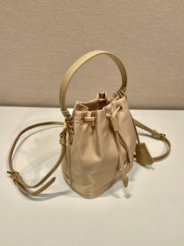 BUCKET BAG 19 IN BEIGE RE-NYLON AND SAFFIANO LEATHER HANDLE
