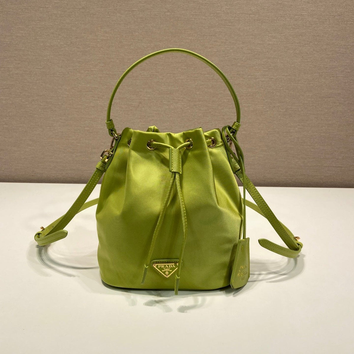 BUCKET BAG 19 IN APPLE GREEN RE-NYLON AND SAFFIANO LEATHER HANDLE